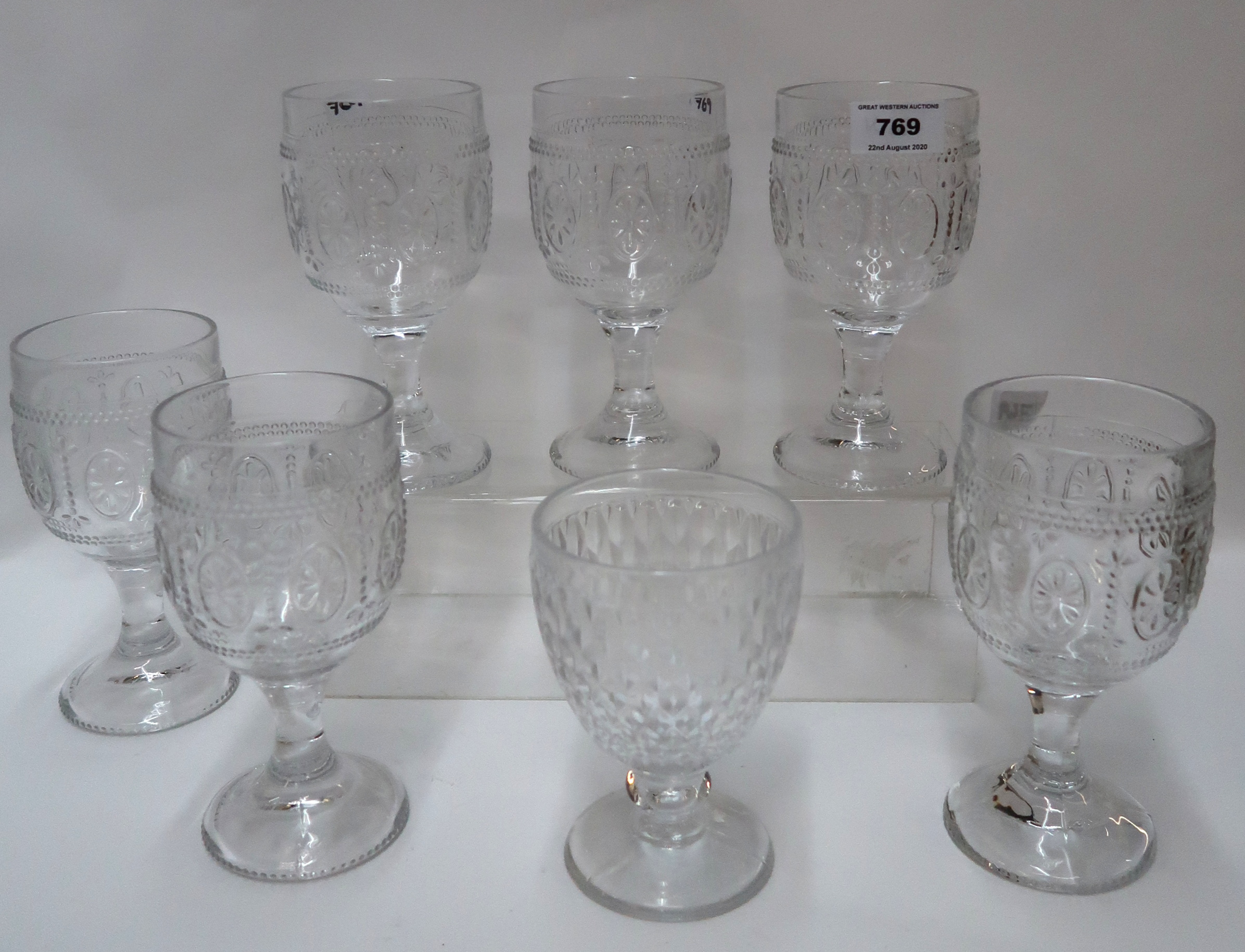 A set of six moulded glasses and another glass Condition Report: Available upon request