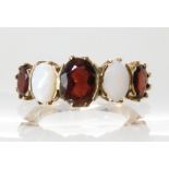 A 9ct gold garnet and white opal ring size Q, weight 4.3gms Condition Report: Available upon