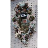 A continental cherub mounted wall sconce, 47cm long Condition Report: some losses to flowers and