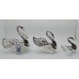 A graduated set of three continental white metal and glass trinket dishes modelled as swans