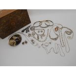An inlaid wooden box containing, silver and white metal, bangles, Mackintosh style items, earrings