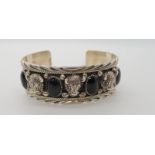 A silver buffalo head and black onyx native American style bangle, Condition Report: No condition