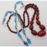 A Mexican silver and turquoise necklace together with a string of cherry amber beads Condition