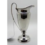 A silver cream jug with faceted body and scrolling handle, 14.5cm high 123gms Condition Report: