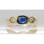 An 18ct gold sapphire and diamond three stone ring, sapphire approx 5mm x 6.5mm x 1.9mm, finger size