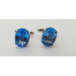 A pair of silver cufflinks set with blue gems Condition Report: No condition report available for