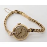 A 9ct gold ladies Timor watch with chain link strap, diameter of watch head 2.2cm, length of strap