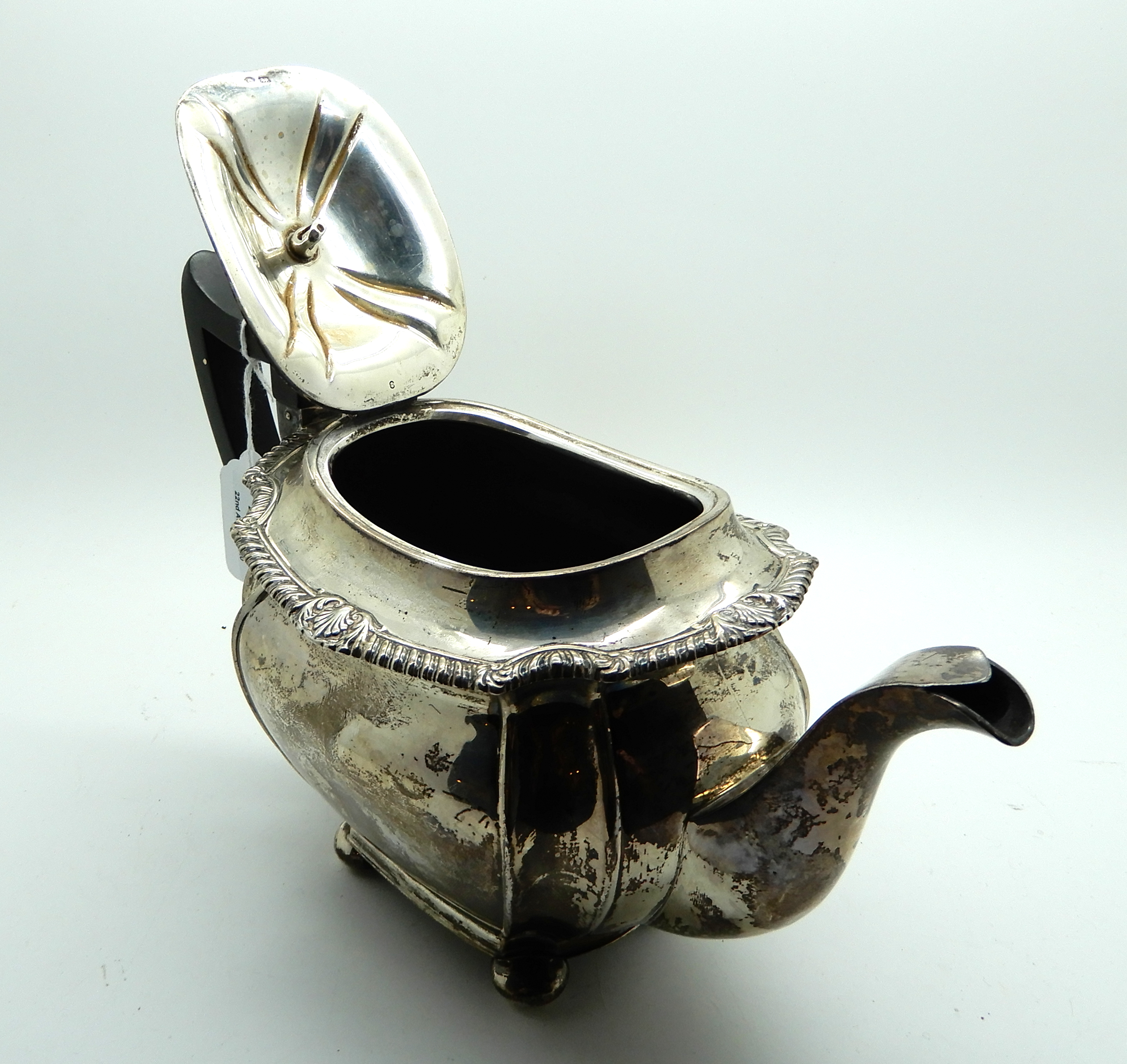 A silver teapot, Sheffield 1919, of rounded rectangular form and four ball feet, 16cm high, 704gms - Image 3 of 4