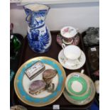A pottery jug with blue painted eagle coat of arms, porcelain stamp box, two carved cowrie shells,
