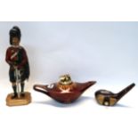 A table lighter in the form of a Scots Guard, a Carlton Ware genie lamp lighter and another