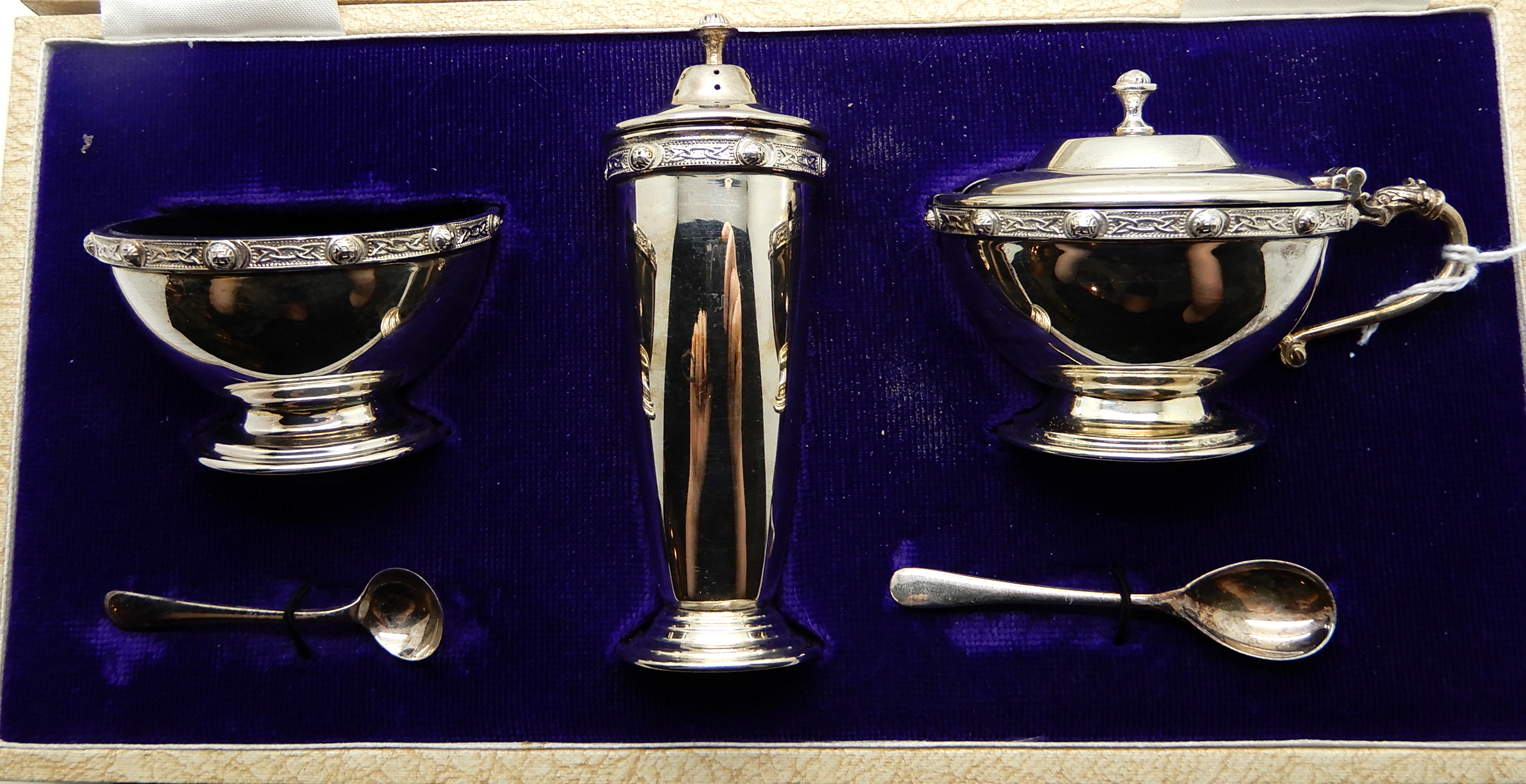 A cased three piece silver condiment set with Celtic decoration, Birmingham 1967 Condition Report: - Image 2 of 4