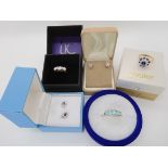 A 9ct gold blue and clear gem ring size O, with matching earrings, a 9ct three clear gem ring with