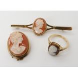 A 9ct gold cameo set bar brooch length 6.5cm, together with an oval example 2.9cm x 2.3cm, and a