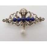 A silver gilt continental brooch of a cherub set with lapis lazuli and pearls Condition Report: No
