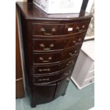 A mahogany bow front cabinet with five drawers and two cupboard doors, 134cm high x 60cm wide x 45cm