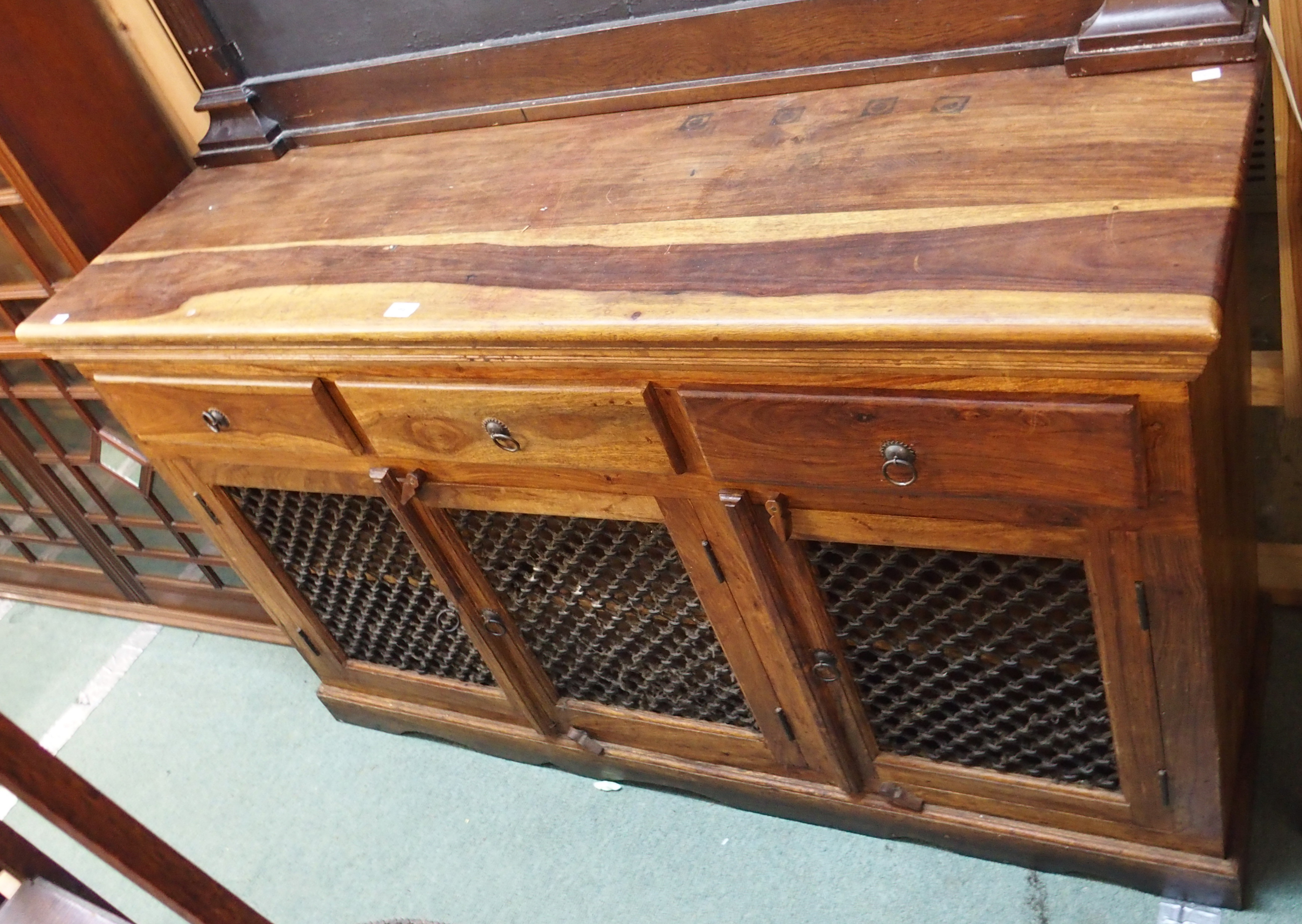 A modern hardwood sideboard with three drawers and three doors with metal grill, 92cm high x 153cm