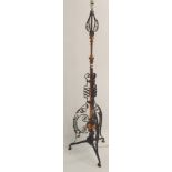 A wrought iron and copper adjustable standard lamp Condition Report: Available upon request