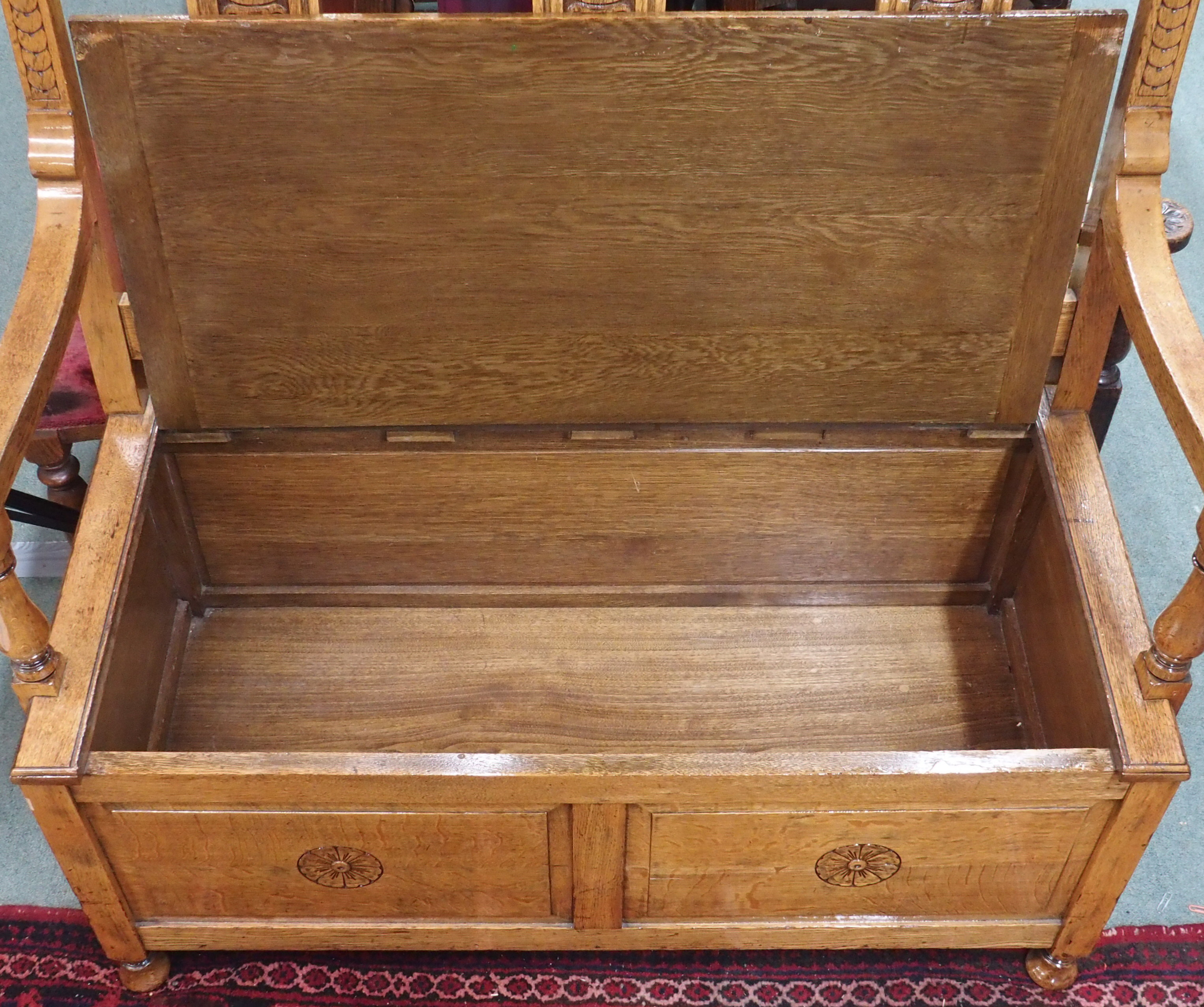 A carved oak bench with lidded seat, 110cm high x 110cm wide x 55cm deep Condition Report: Available - Image 3 of 3