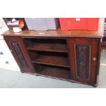 A mahogany sideboard with open shelves and two carved doors, 81cm high x 138cm wide x 50cm deep