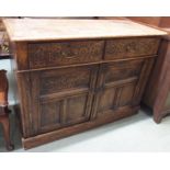 A carved oak sideboard with two drawers and two cupboard doors, 94cm high x 129cm wide x 52cm deep