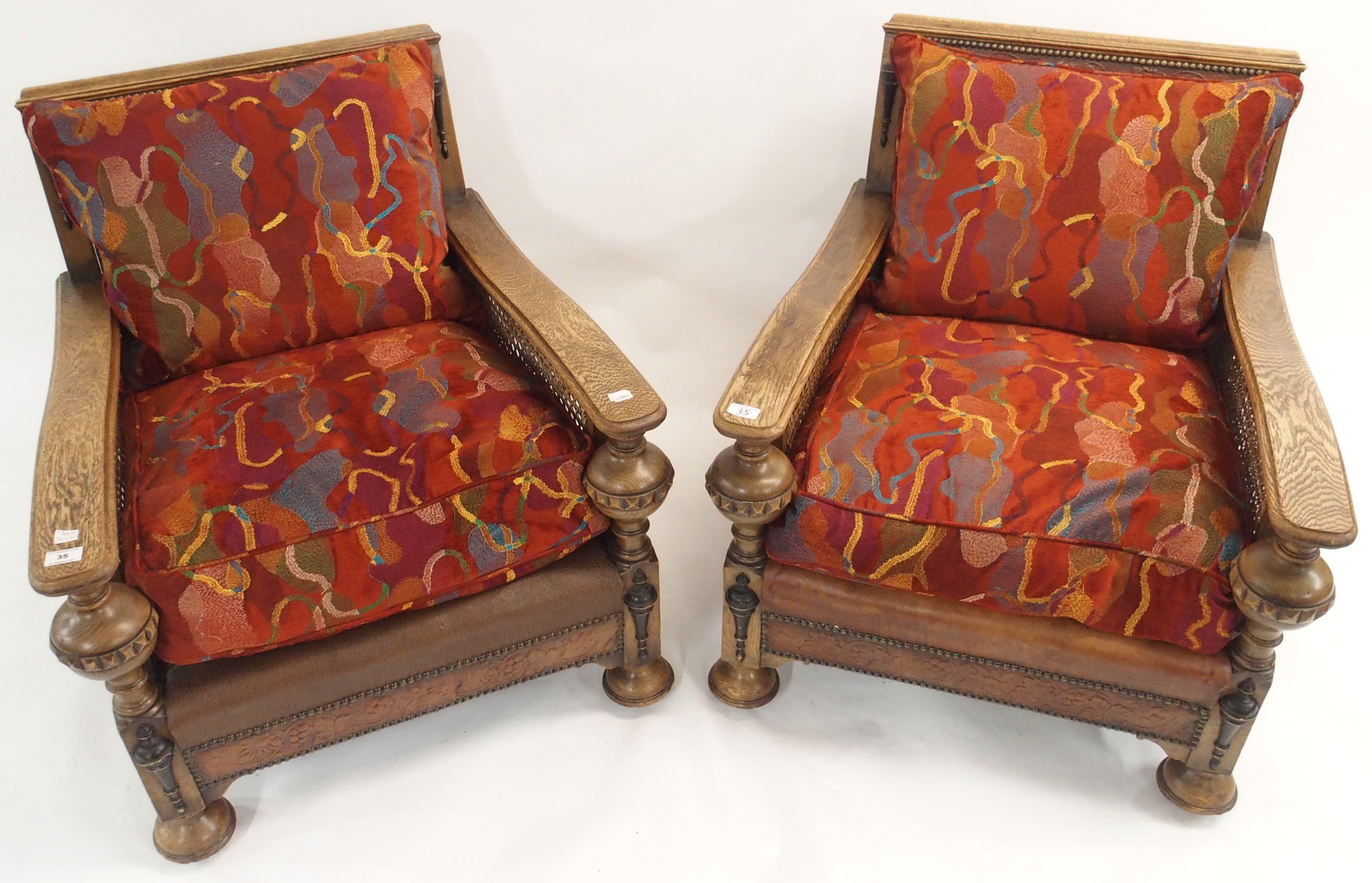 A pair of oak Bergere chairs with leather panels (2) Condition Report: Available upon request