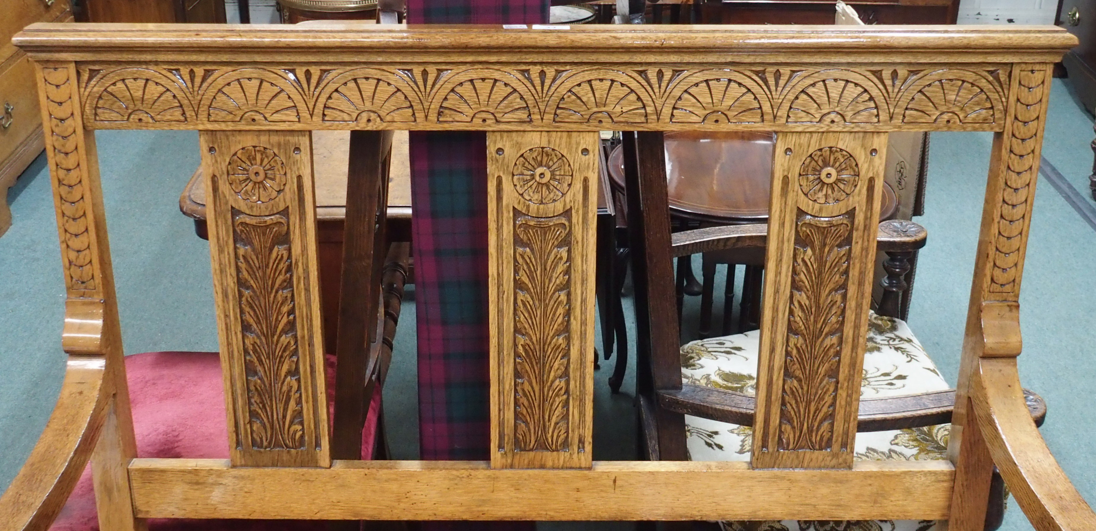 A carved oak bench with lidded seat, 110cm high x 110cm wide x 55cm deep Condition Report: Available - Image 2 of 3