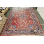 A red ground Keshan rug with blue central medallion, 342cm x 230cm Condition Report: Available