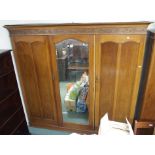 A mahogany triple wardrobe with central mirrored door, 200cm high x 209cm wide x 57cm deep Condition