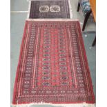 A red ground Bokhara rug, 152cm x 96cm and a prayer rug (2) Condition Report: Available upon