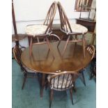 A dark Ercol dining suite comprising drop leaf dining table, 70cm high x 124cm wide x 112cm deep and