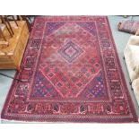 A red ground Eastern rug, 210cm x 300cm Condition Report: Available upon request
