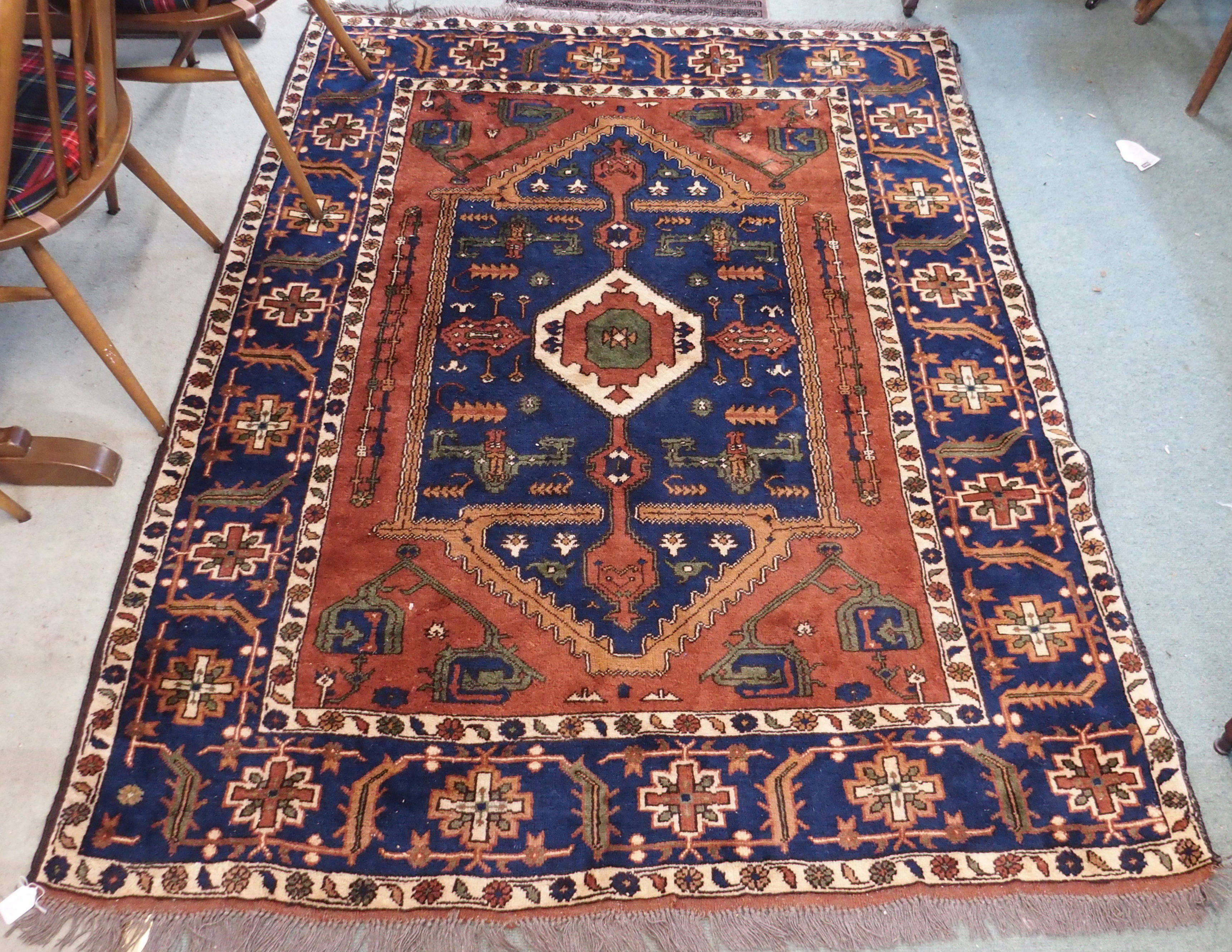 A terracotta ground Eastern rug with geometric design, 204cm x 150cm Condition Report: Available