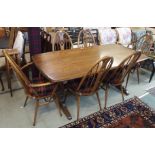 An Ercol Golden Dawn refectory dining table, 74cm high x 181cm wide x 87cm deep with two swan back