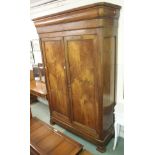 A very large mahogany twin door wardrobe on bracket feet, 234cm high x 150cm wide x 61cm deep