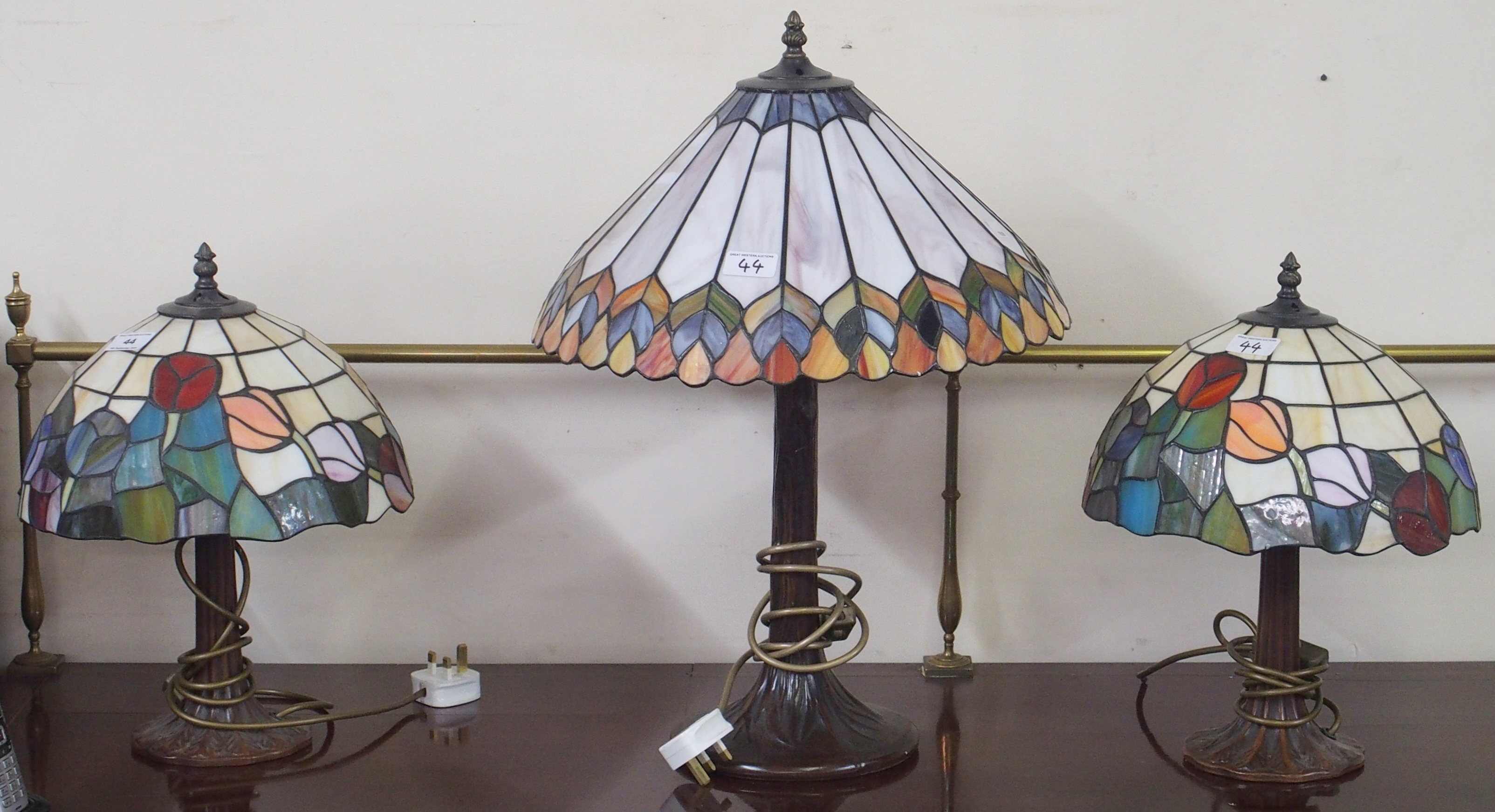 A pair of Tiffany style table lamps and a larger Tiffany style table lamp (3) Condition Report: