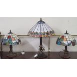 A pair of Tiffany style table lamps and a larger Tiffany style table lamp (3) Condition Report: