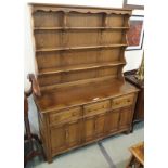 An Ercol Golden Dawn dresser with open shelves and a base with three drawers and three cupboard