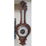 A Victorian carved oak aneroid thermometer/barometer Condition Report: Available upon request