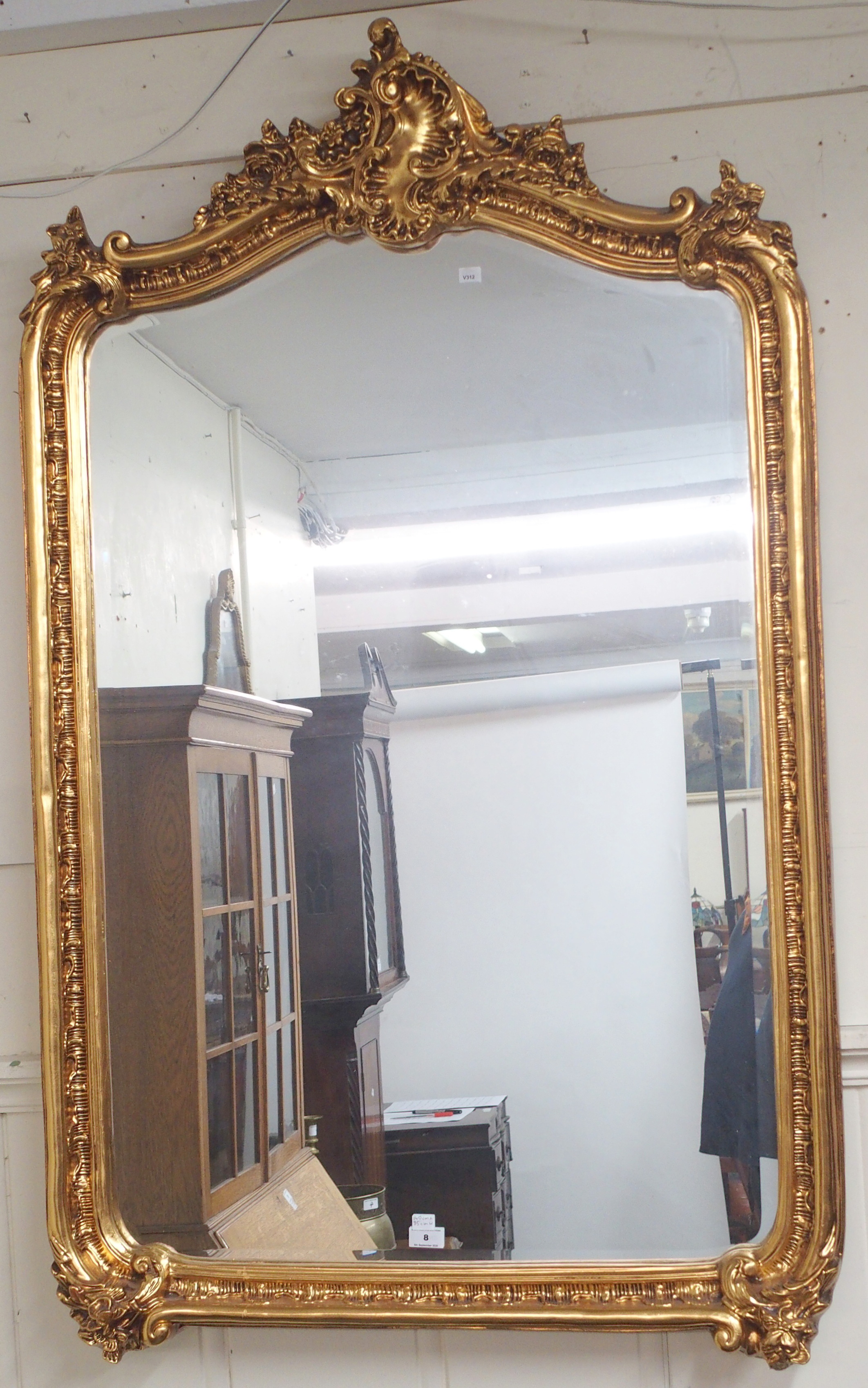 A modern ornate gilt wall mirror, 140cm high x 85cm wide Condition Report: Available upon request