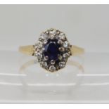 A 9ct sapphire and diamond cluster ring, set with estimated approx 0.20cts of brilliant cut