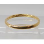 An 18ct gold wedding ring size Q1/2, weight 2gms Condition Report: Available upon request