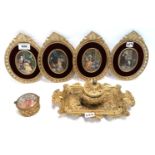 Four overpainted panels of couples in gilt metal frames, together with a cast metal inkwell and a