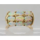 A 9ct gold jelly opal cluster ring, finger size N, weight 4.3gms With a GemsTV certificate Condition