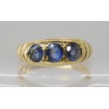 An 18ct gold three sapphire ring, size R, weight 4.2gms Condition Report: Available upon request