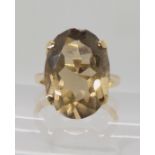 A bright yellow metal ring set with smoky quartz, size Q, weight 5.1gms Condition Report: