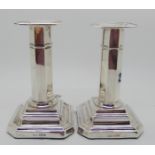 A pair of silver candlesticks, Sheffield 1918, the octagonal stem on stepped square pedestal base