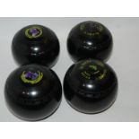 A set of four Almark modern lawn bowls and 12 volume of Children's Britannica in book trough