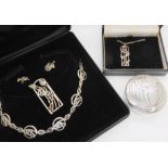 A boxed set of Mackintosh jewellery to include a necklace, brooch and earrings, a further pendant