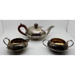 A three piece silver tea service, London 1906, 976gms Condition Report: Available upon request