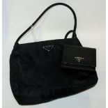 A ladies handbag and wallet stamped Prada Condition Report: Available upon request